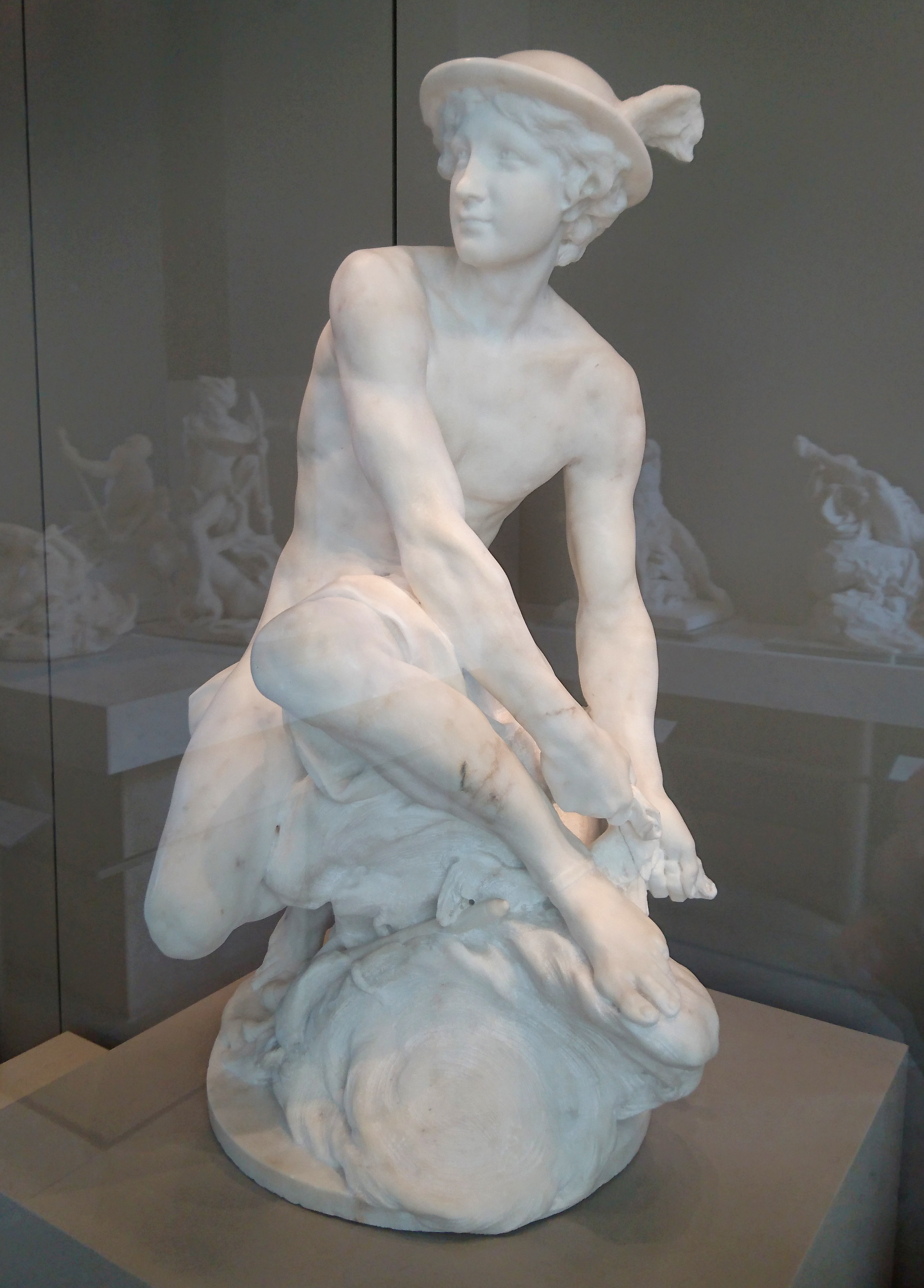 Jean-Baptiste Pigalle's Mercury Attaching His Wings, a youthful idealized male nude in marble